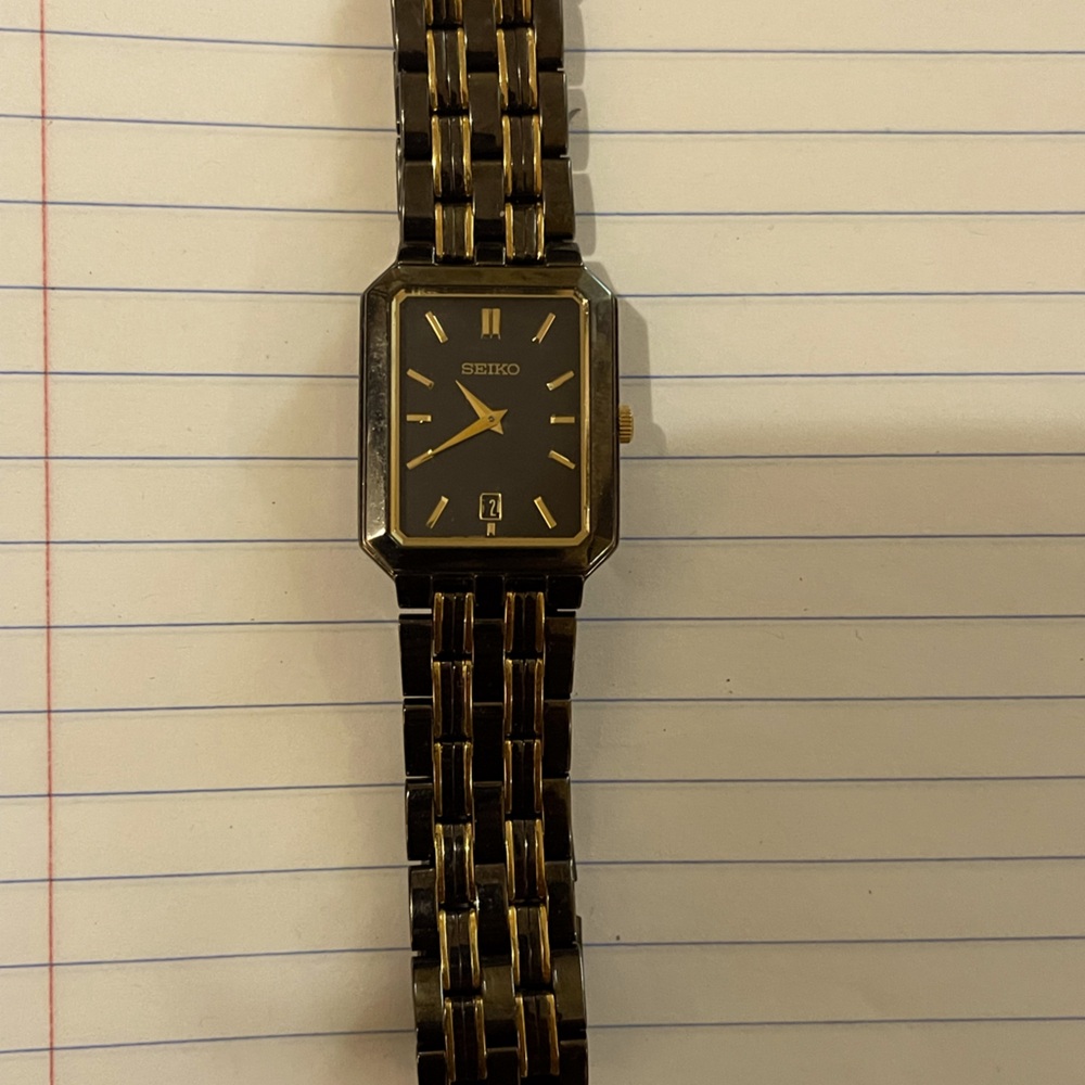 Women’s SEIKO watch in a black/charcoal with gold accents.